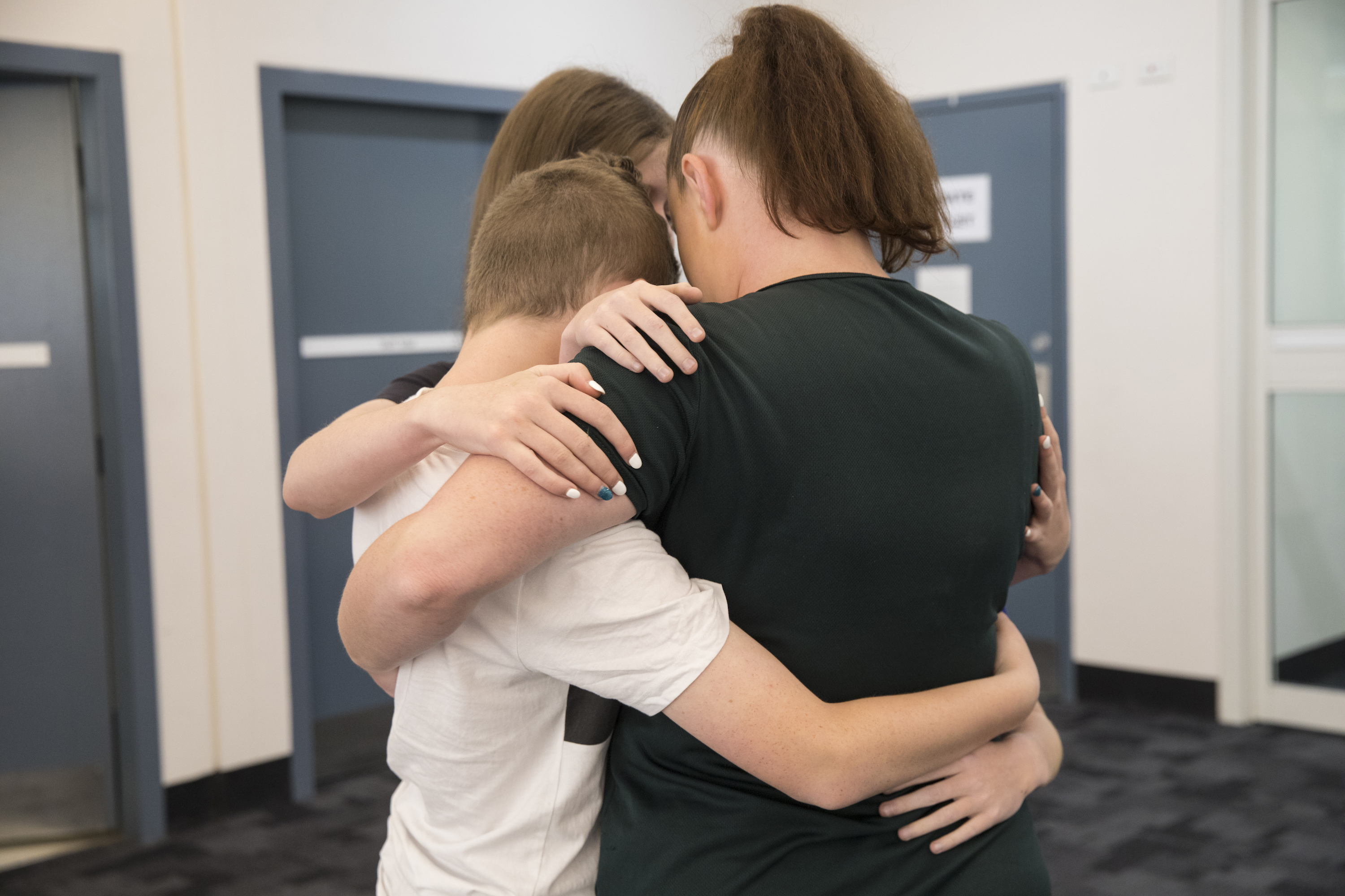 A mother hugs her kids at Dillwynia correctional centre.