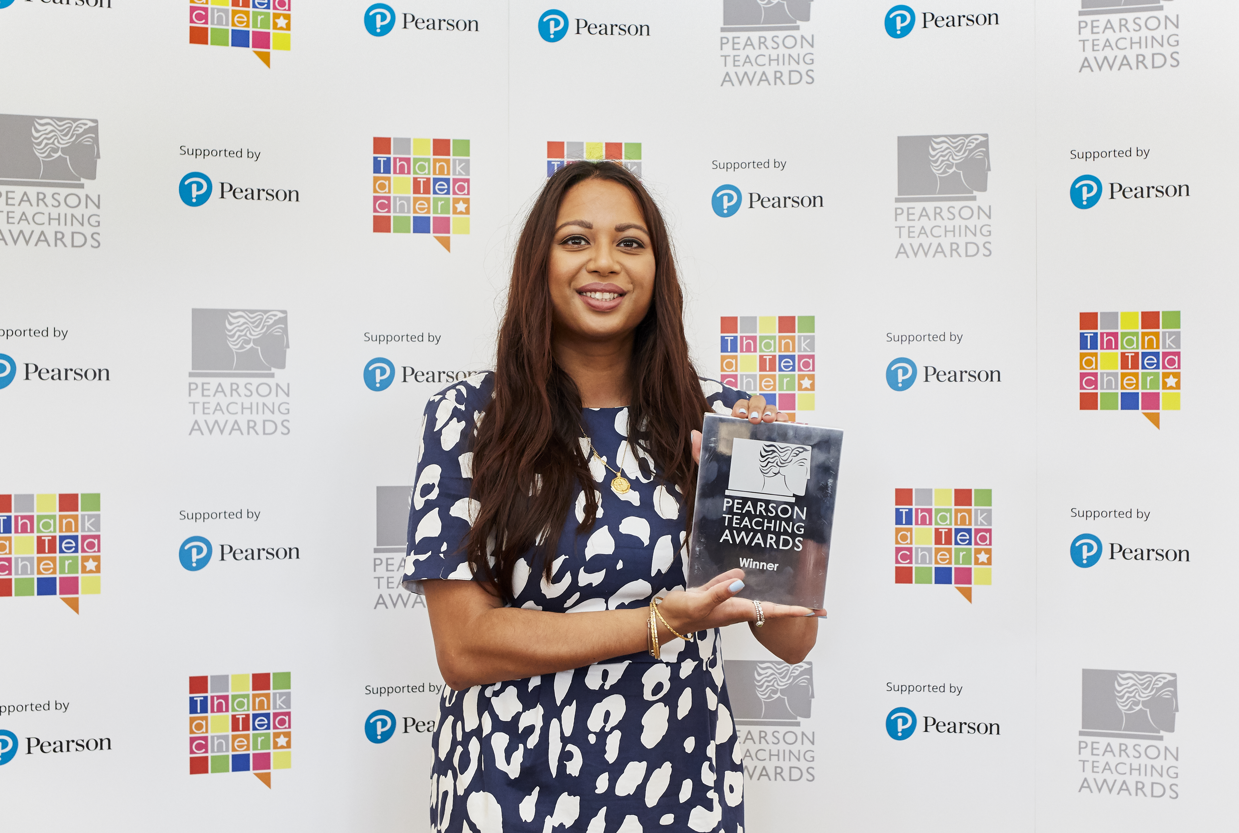 Shalina Patel accepts her Pearson National Teaching Awards silver winner's trophy.