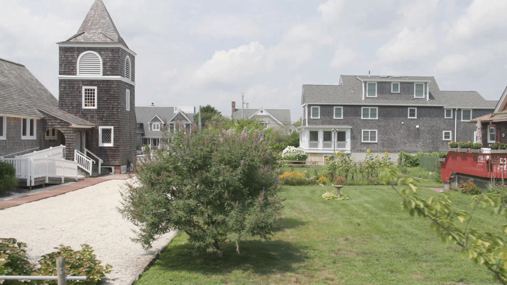 A suburban neighborhood increasingly floods with water from now until 2100.